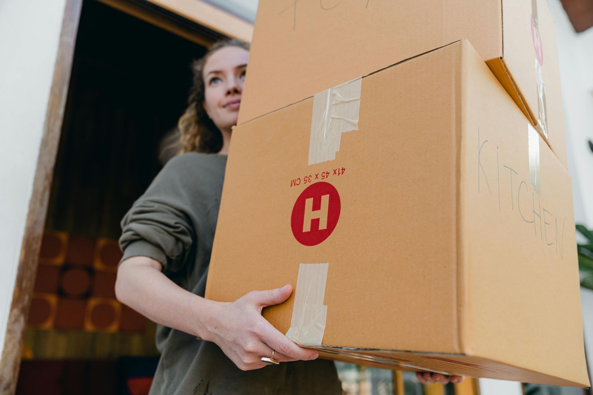 A professional mover hauling out boxes