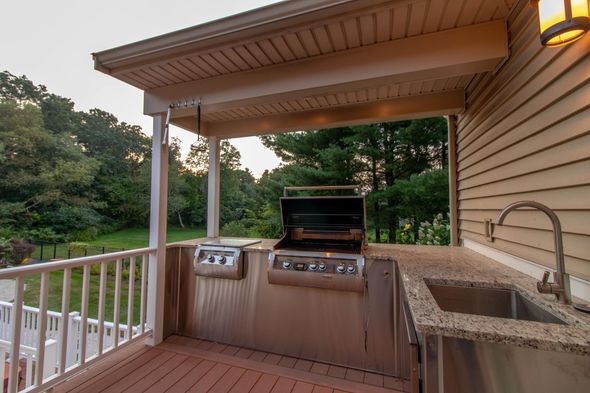Image of an outdoor kitchen set complete with a grill and kitchen sink.