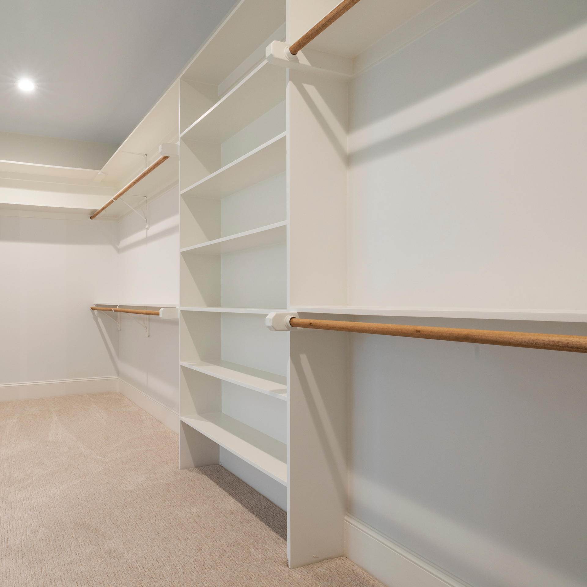 Image of an interior closet organizer and hanging rods.