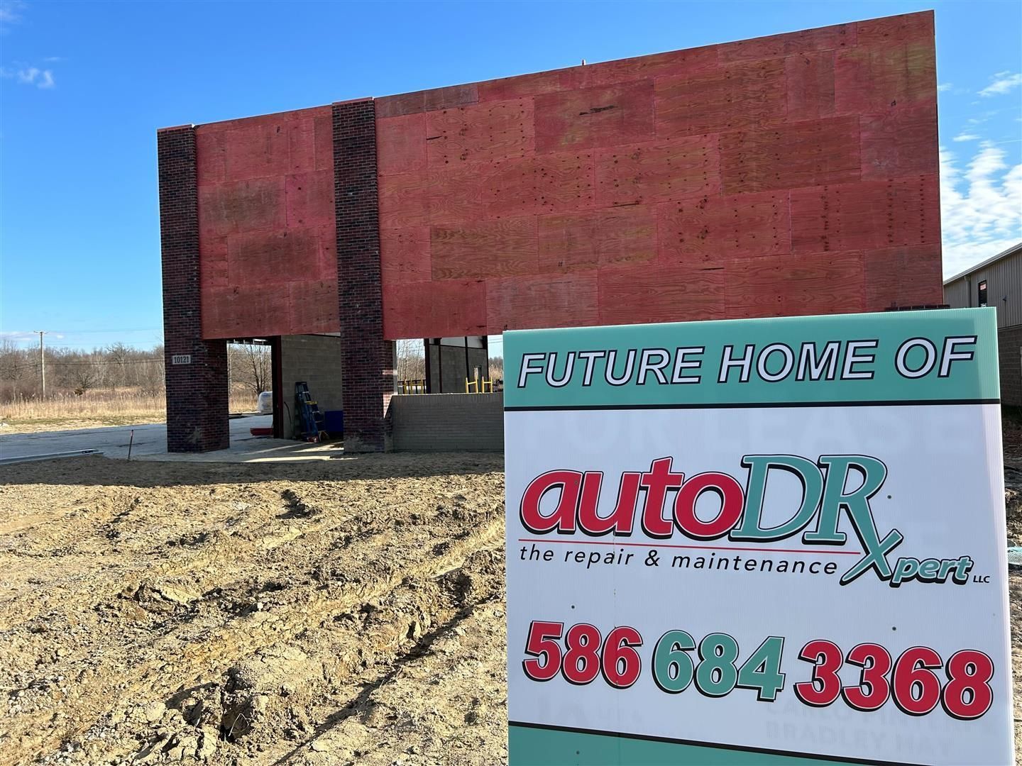 Auto DR Future Location Sign Displayed Outside New Building | Auto DR