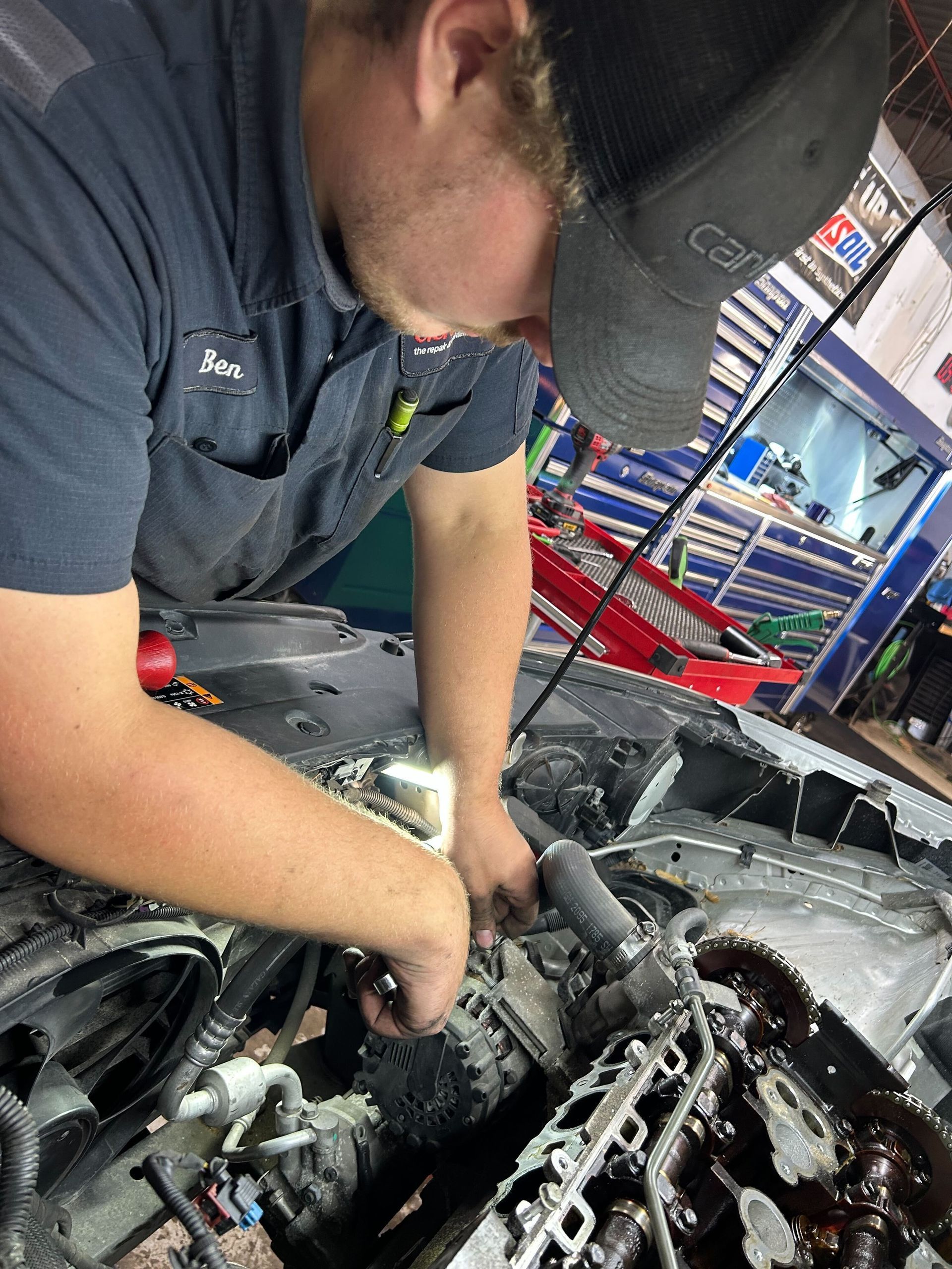Technician Performing Engine Repair Inside Auto Repair Facility | Auto DR