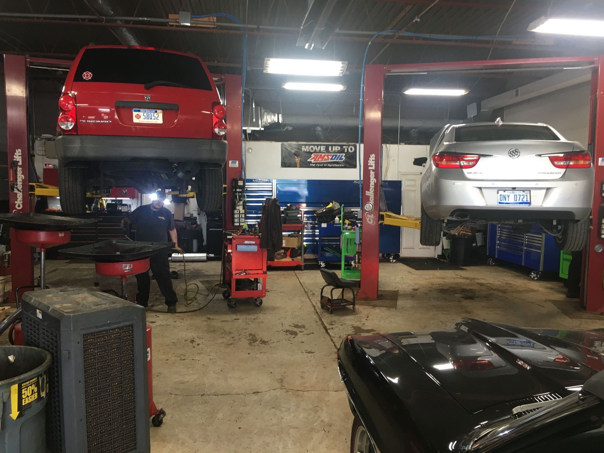 Vehicles Raised On Lifts Inside Busy Auto Repair Shop | Auto DR