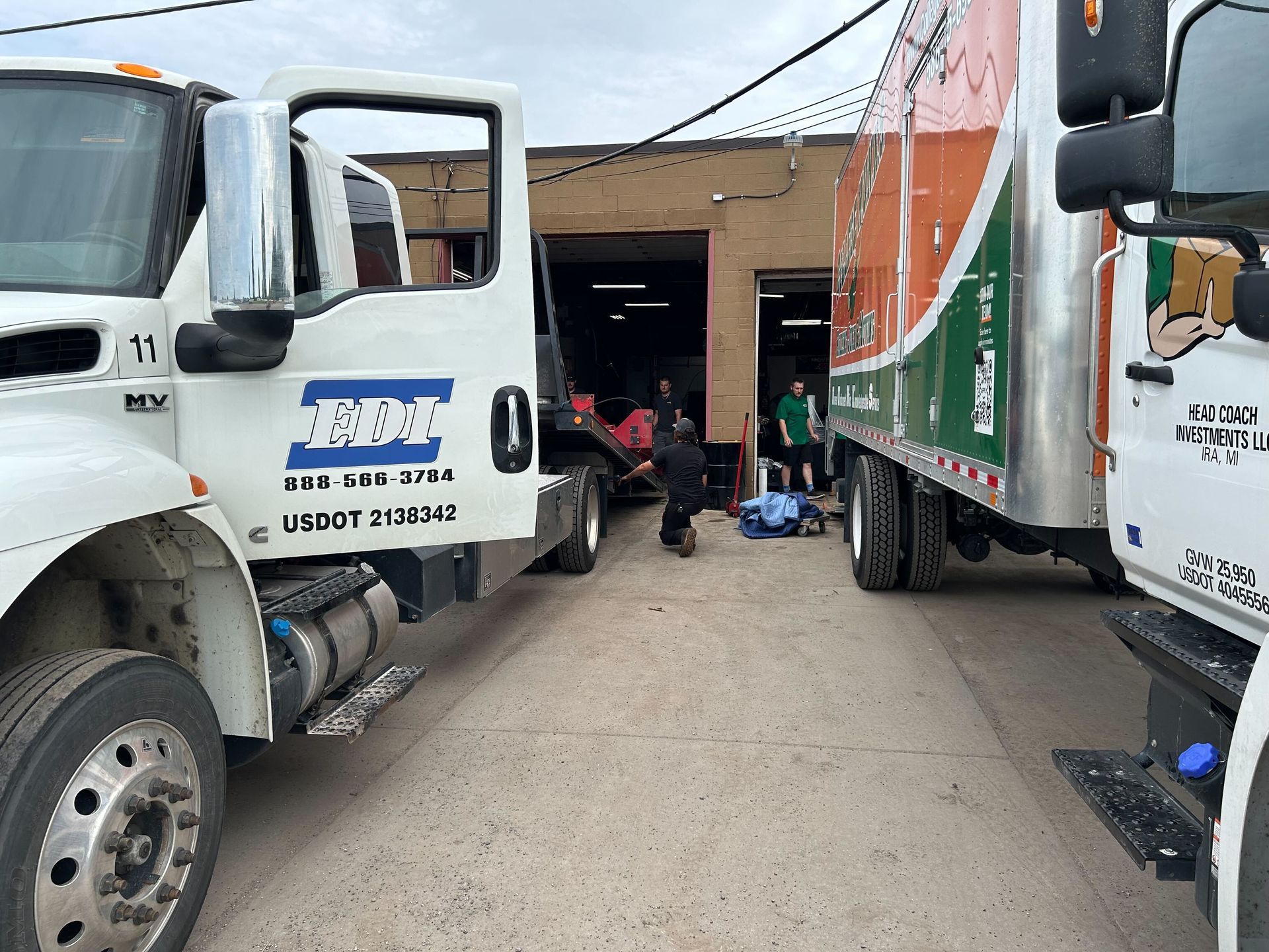 Service Trucks Positioned Inside Auto Repair Facility | Auto DR