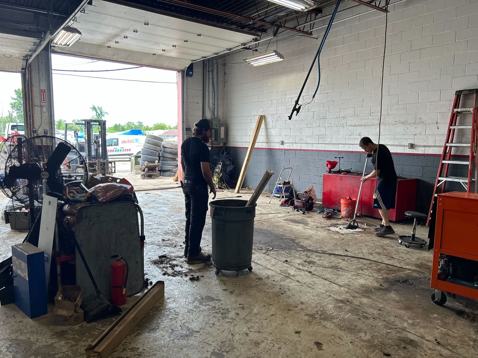 Technicians Working Inside Auto Repair Shop During Setup | Auto DR