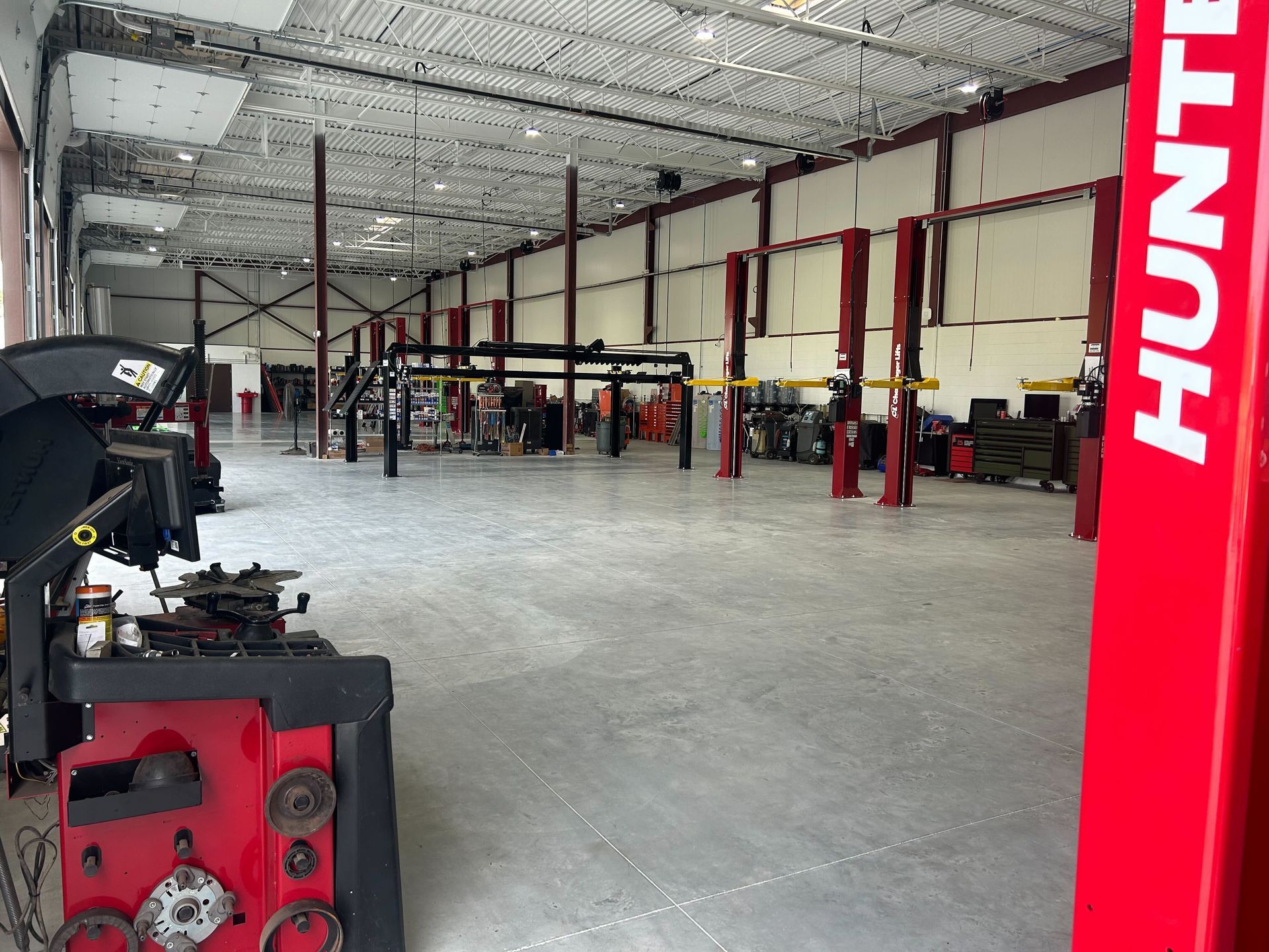 Spacious Auto Repair Shop Interior With Vehicle Lifts Installed | Auto DR