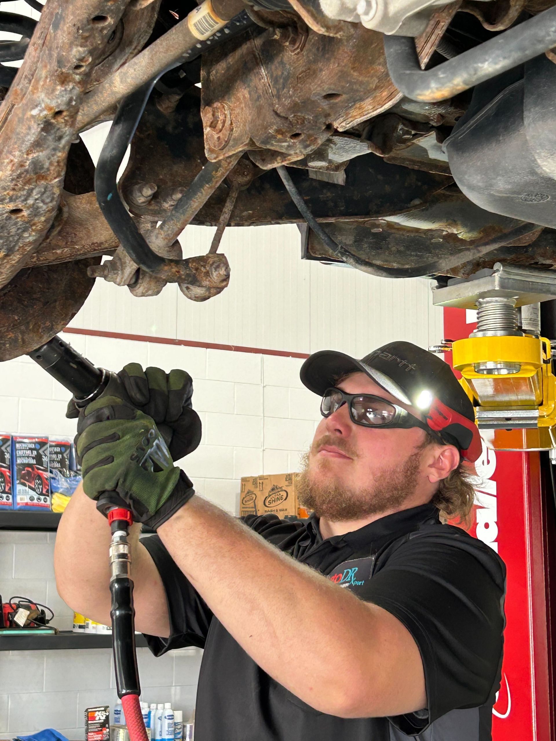 Mechanic Tightening Undercarriage Bolts During Repair | Auto DR
