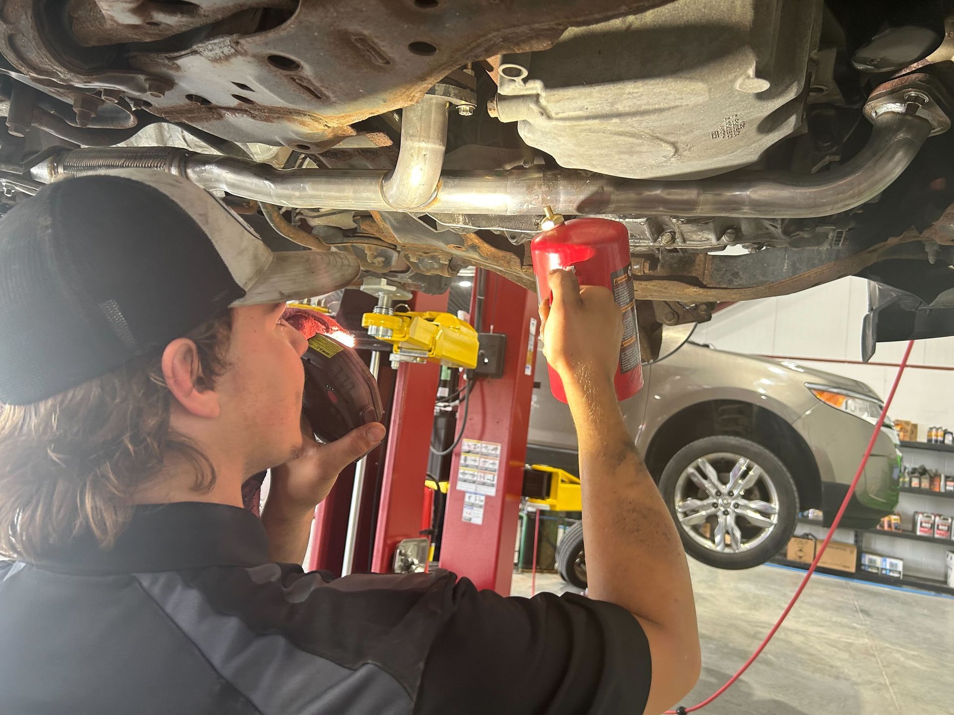 Technician Adjusting Suspension Components Under Vehicle | Auto DR