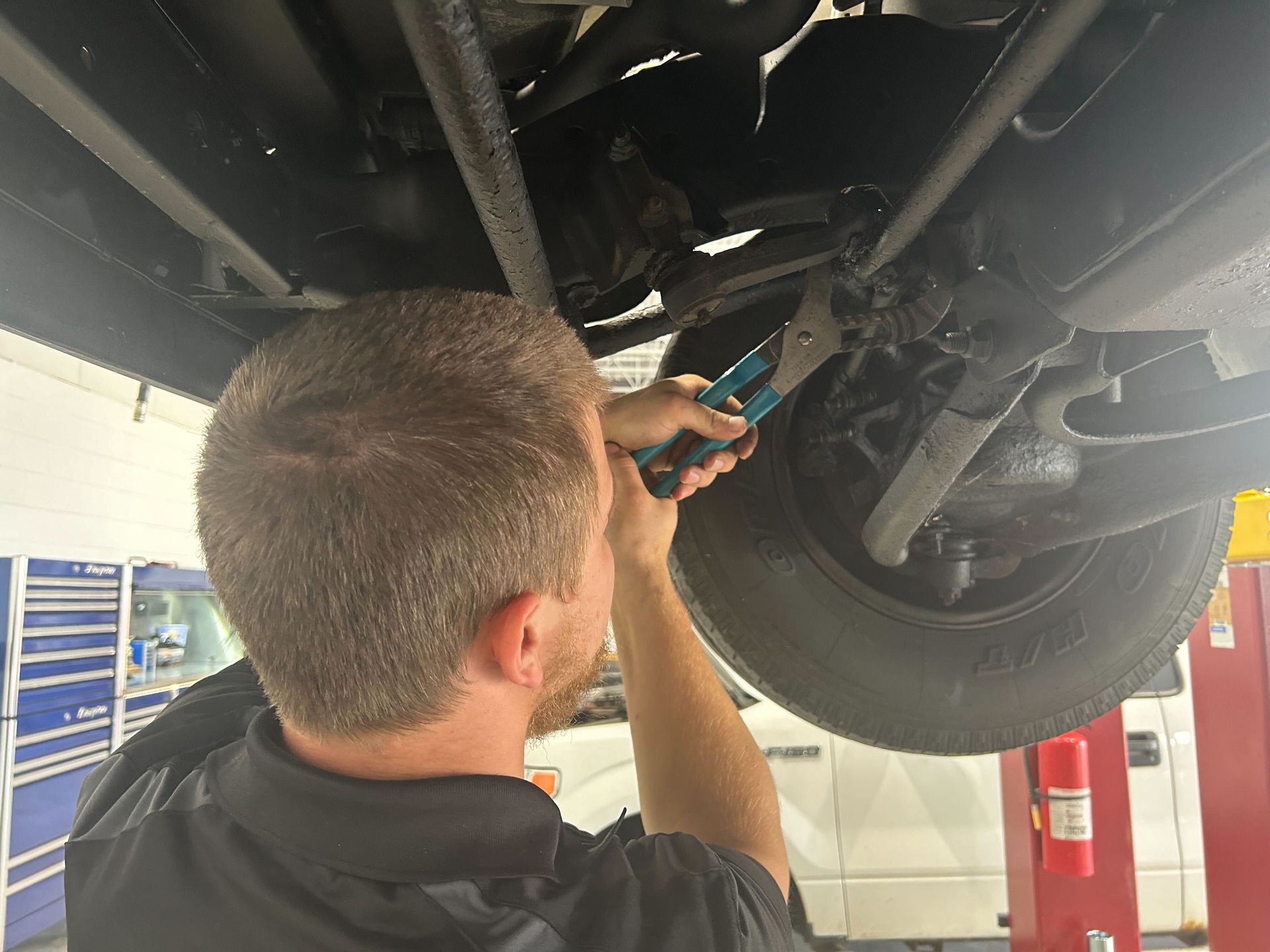 Mechanic Inspecting Steering And Suspension System | Auto DR
