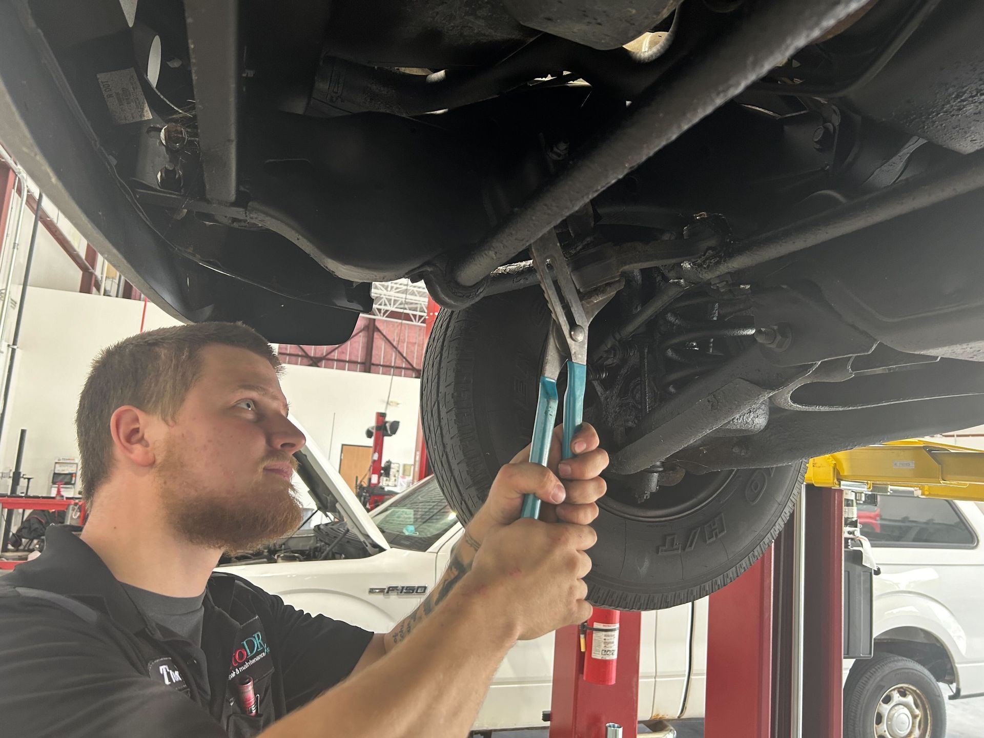 Automotive Suspension Repair Performed On Lifted Vehicle | Auto DR
