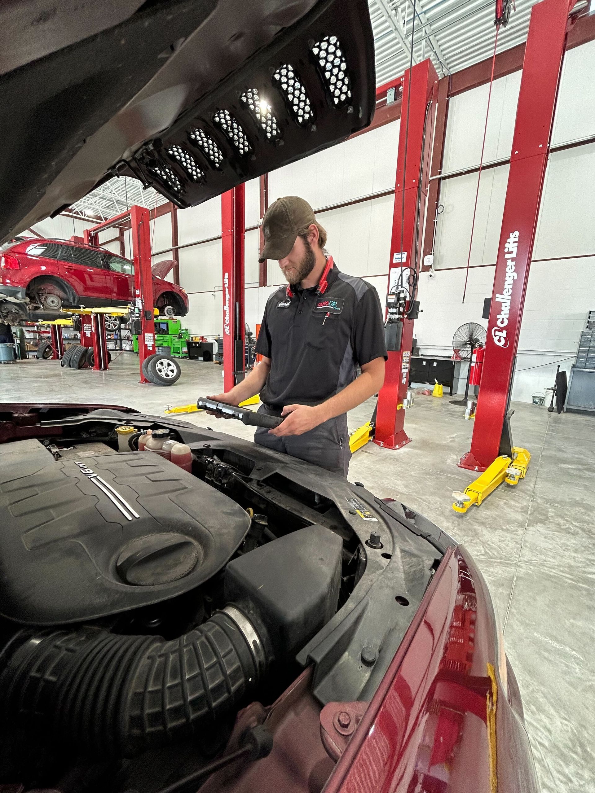Automotive Technician Performing Engine Inspection Inside Service Bay | Auto DR