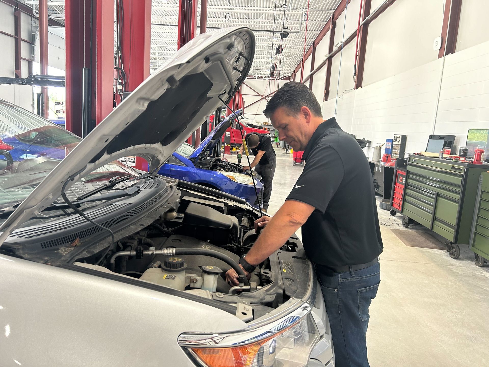 Mechanic Working On Engine Repair With Hood Open | Auto DR