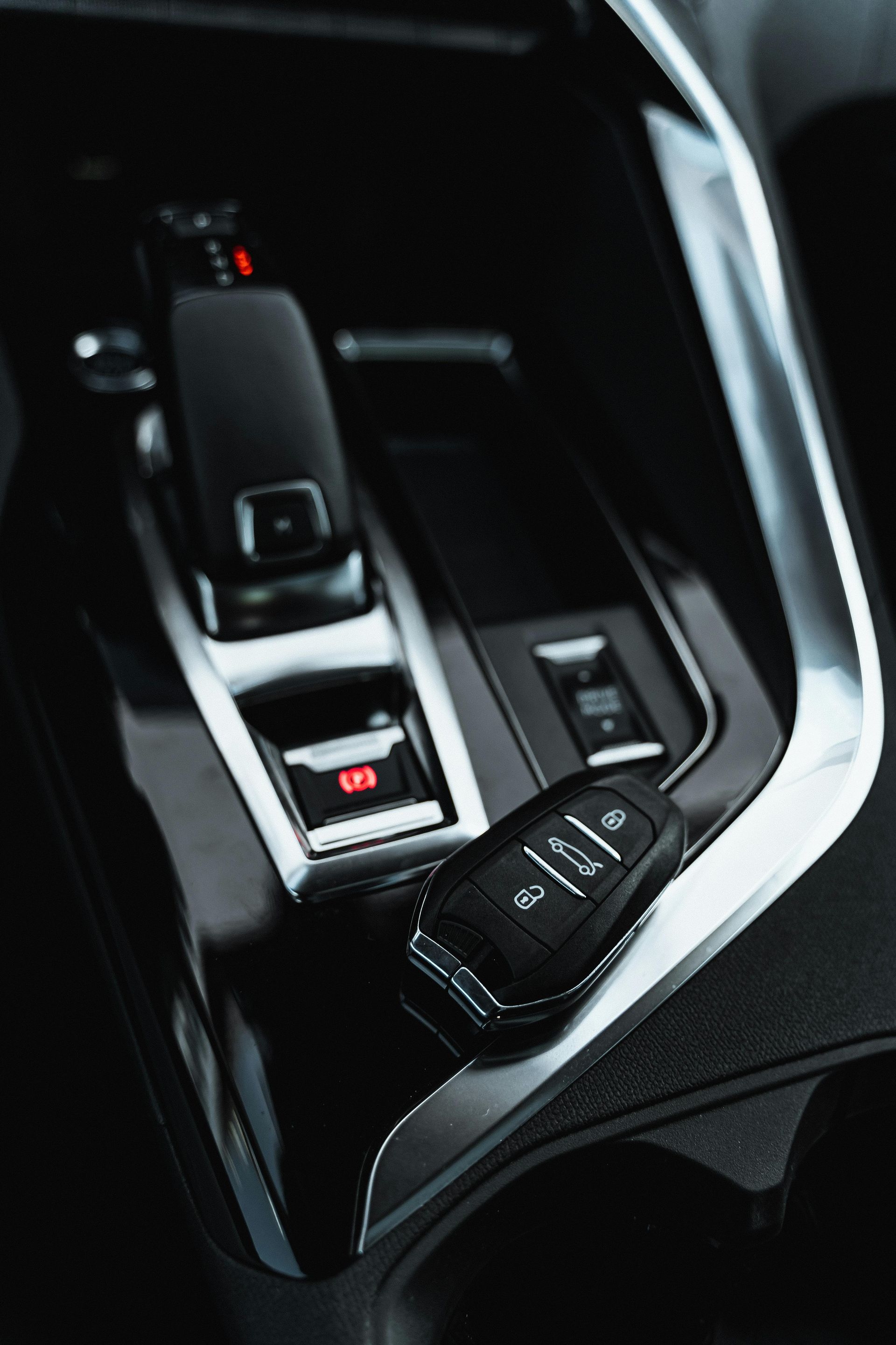 A close-up of a Buick's interior showing the center console and key fob.