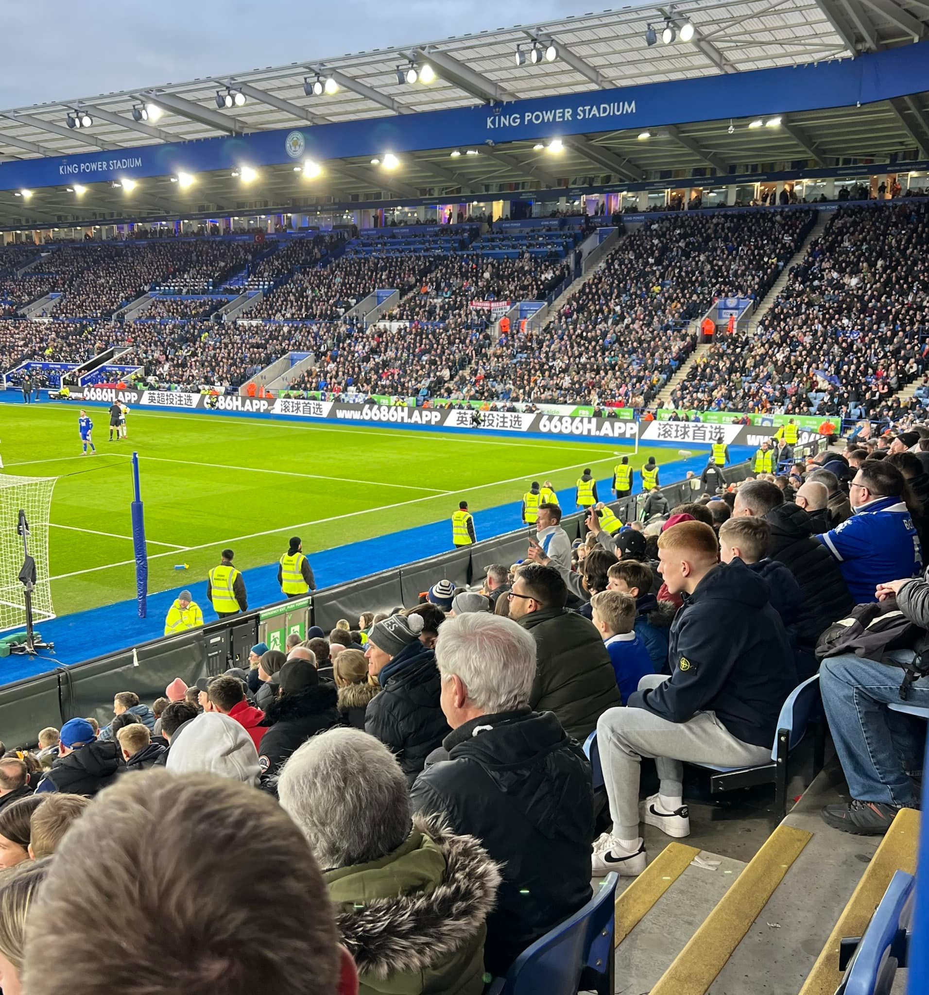 A crowd of people are watching a soccer game in a stadium