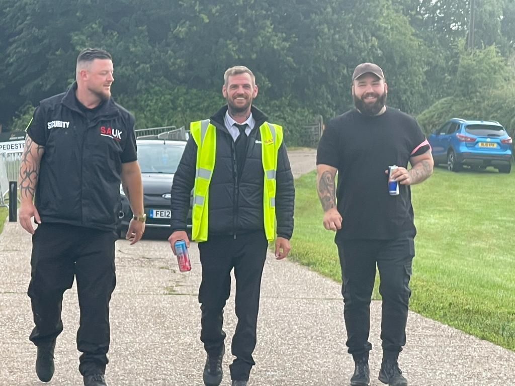 a group of men are walking down a road .