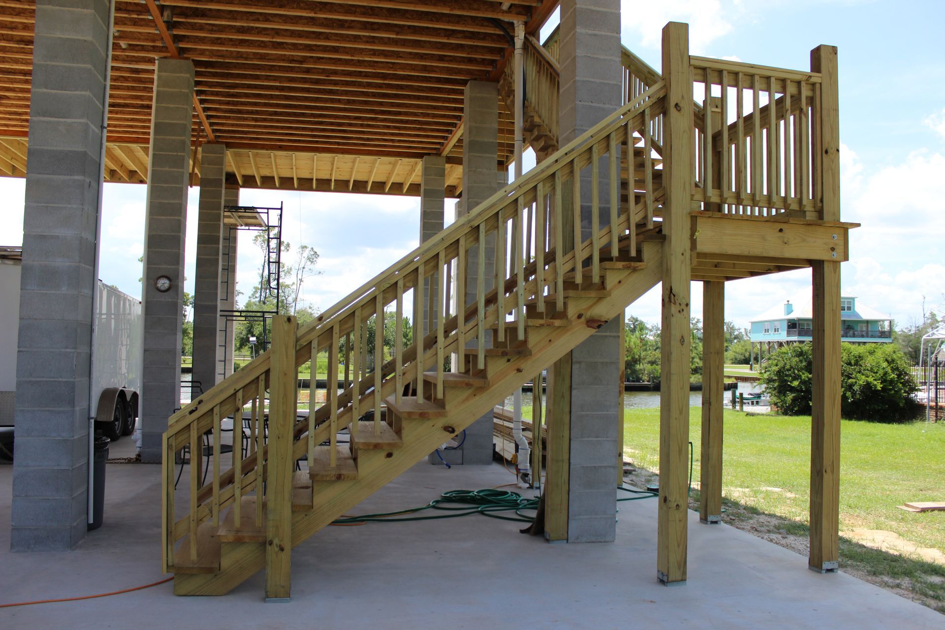 A wooden staircase leading up to a deck under construction