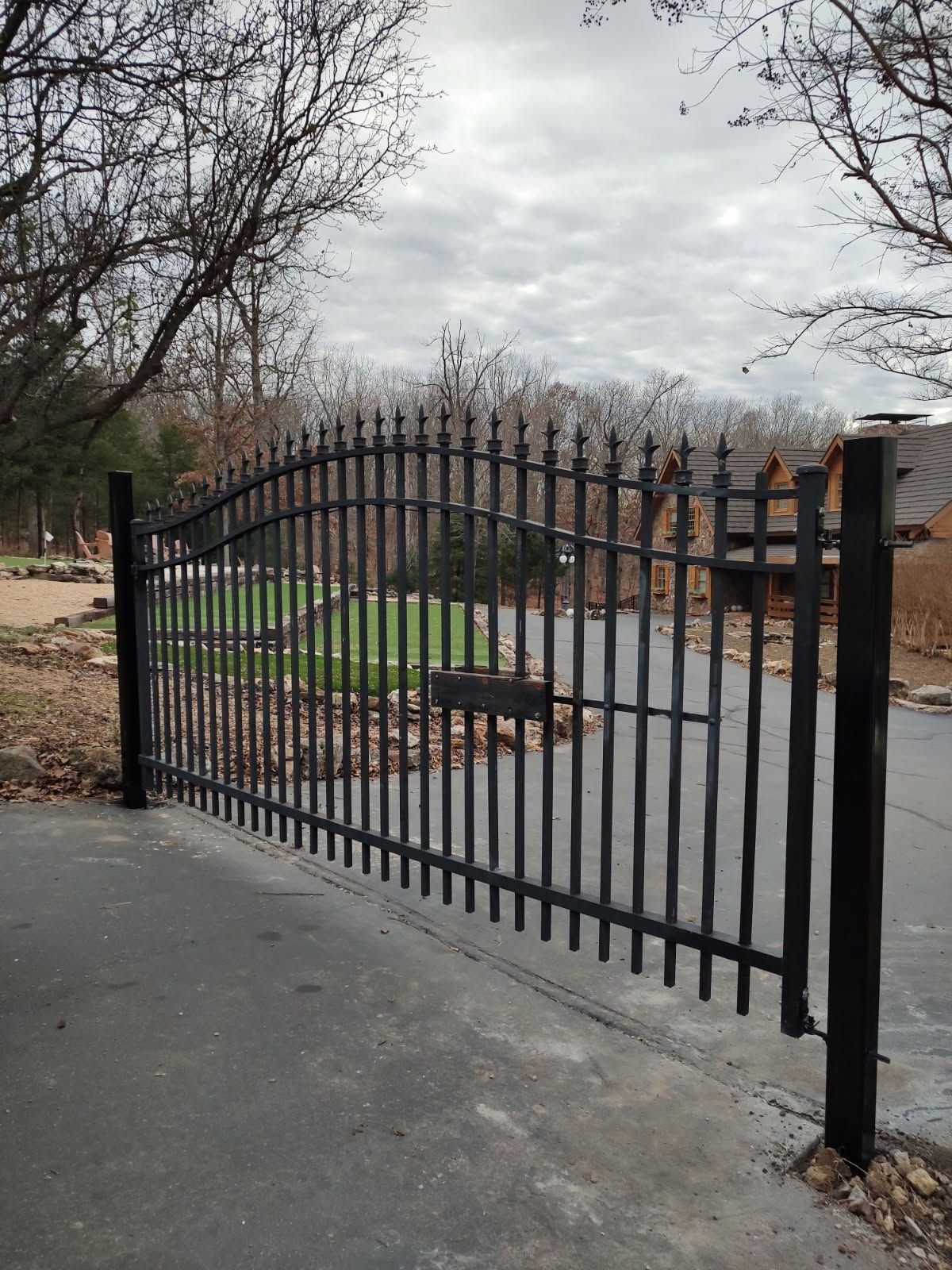 Driveway gate and access fencing installed for a Nixa area property