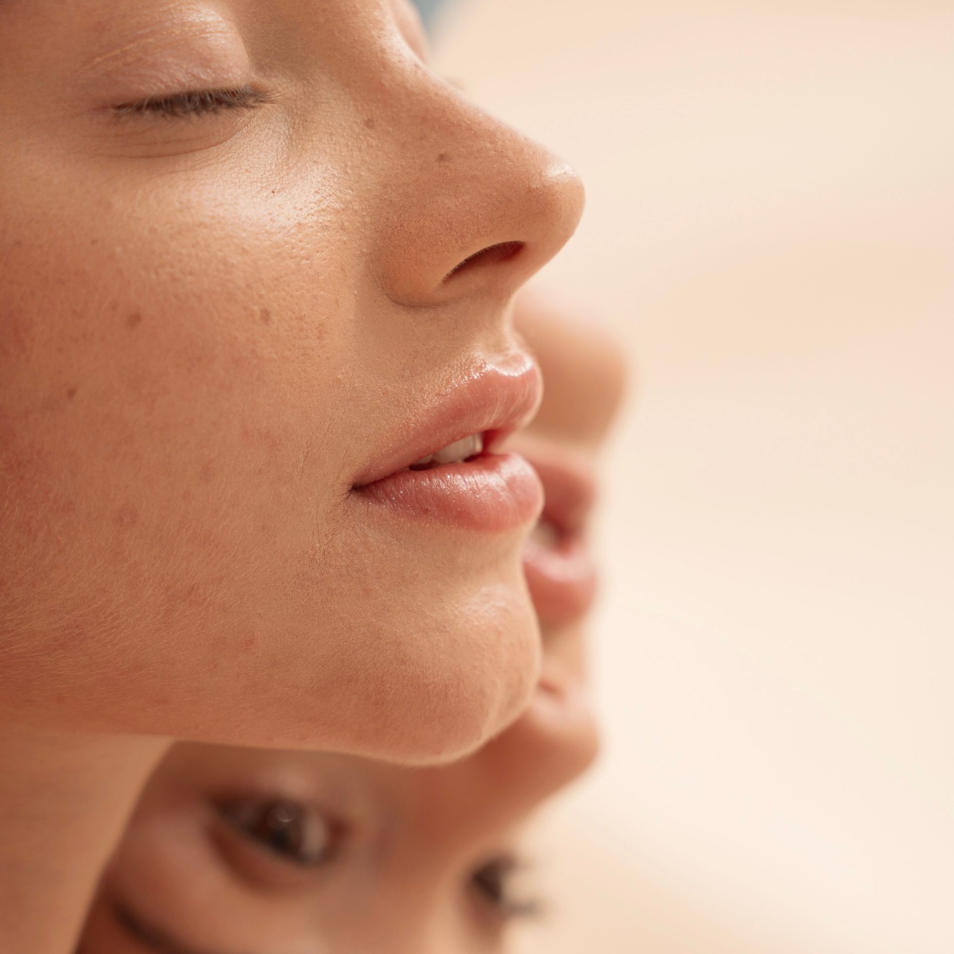 A close up of a woman 's face with her eyes closed.