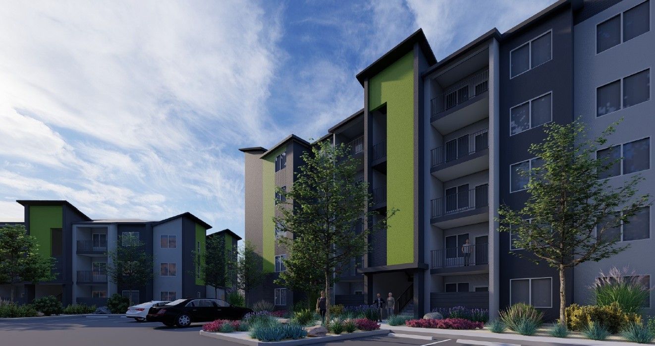 Modern apartment complex with green accents, balconies, and landscaped courtyard under a cloudy sky