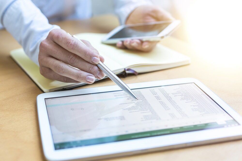 A Person Is Using A Pen To Write On A Tablet — Visionary Accounting In Dubbo, NSW