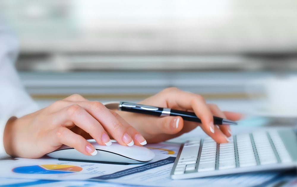 A Woman Is Typing On A Keyboard While Holding A Pen — Visionary Accounting In Forbes, NSW