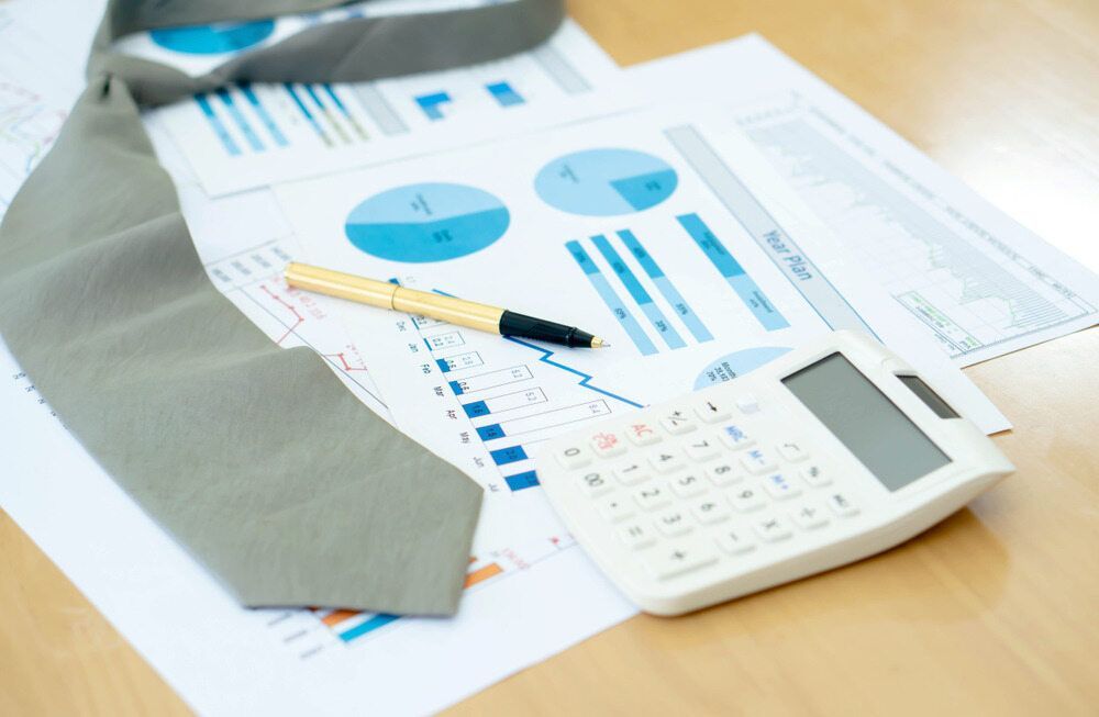 A Tie A Pen And A Calculator Are On A Table — Visionary Accounting In Bourke, NSW