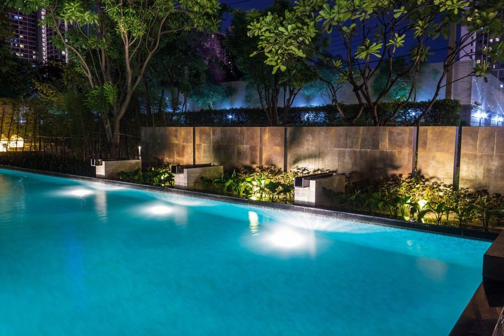 A lArge Swimming Pool is Lit Up at Night — Focus On Water In Cannonvale, QLD