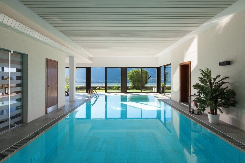 A Large Indoor Swimming Pool With a Lot of Windows —  Focus On Water In Cannonvale, QLD