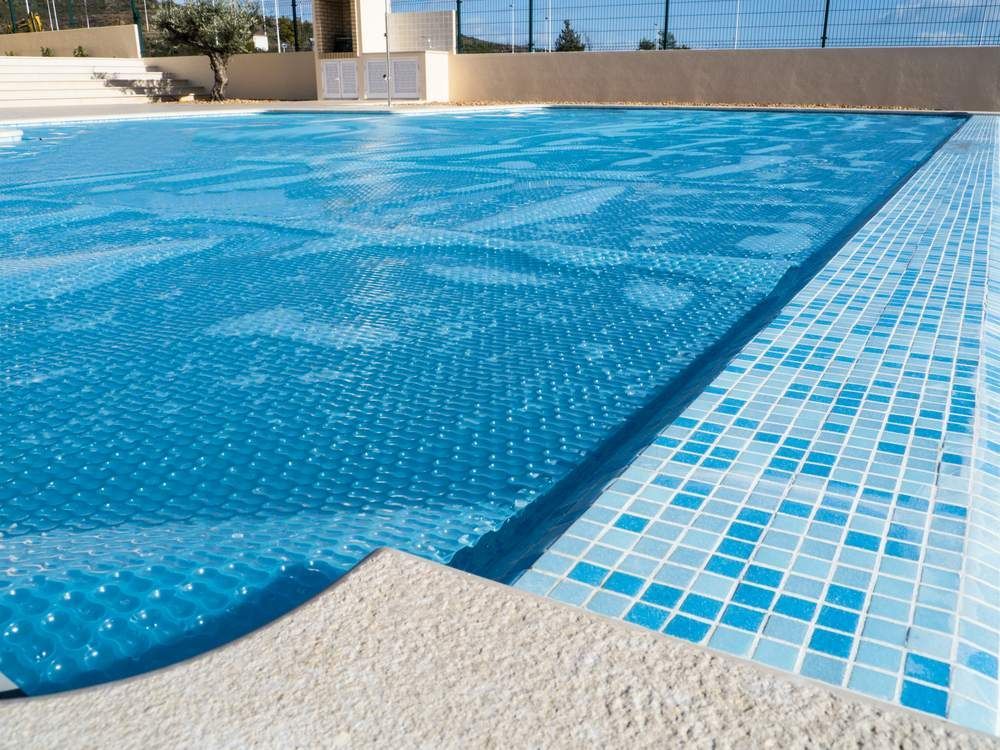 A lArge Swimming Pool With a Blue Cover on It —  Focus On Water In Cannonvale, QLD