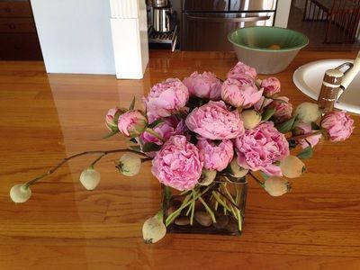 A vase filled with pink flowers on a wooden table