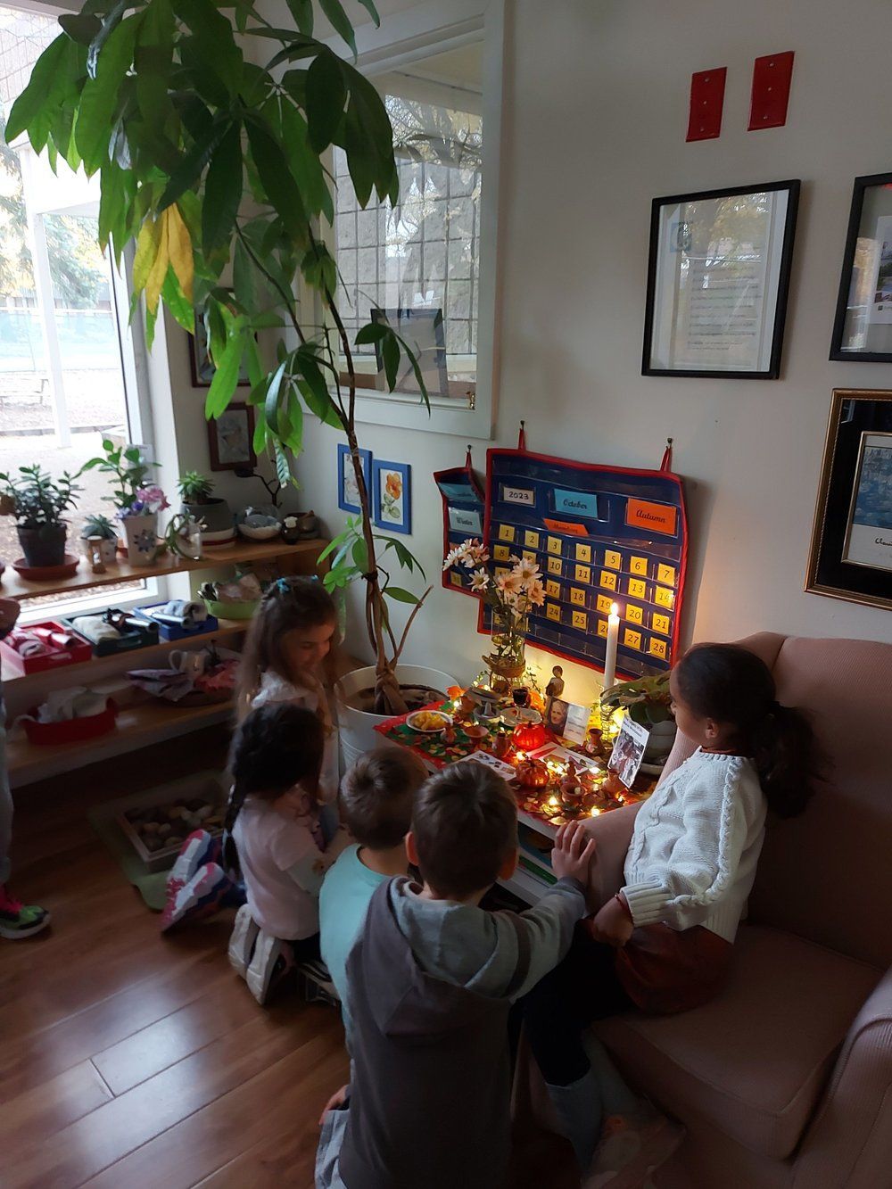 A group of children are sitting on a couch in a living room.