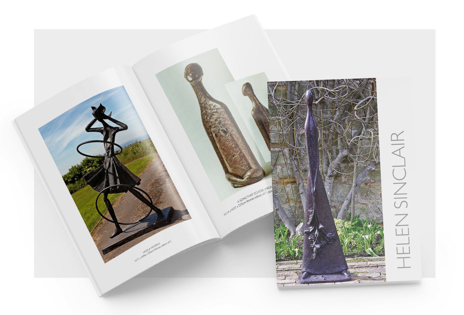 A book is open to a page with a statue on it.
