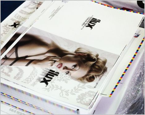 A stack of lux magazines with a woman on the cover