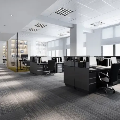Modern open-plan office with black cubicles, chairs, and large windows in a bright, minimalist space