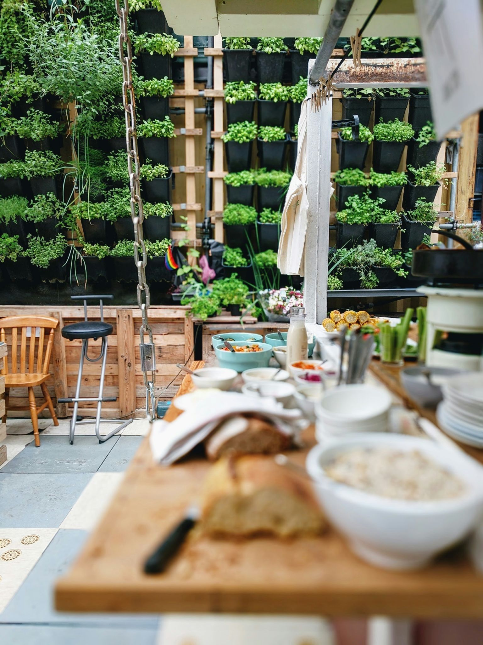 The counter of an outdoor kitchen full of a variety of different foods