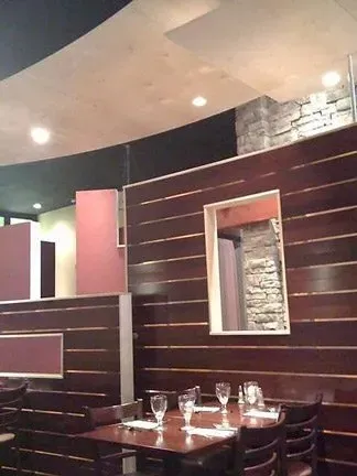 A dining room with a round table and chairs