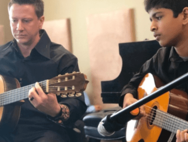 child received a guitar lesson from a teacher 