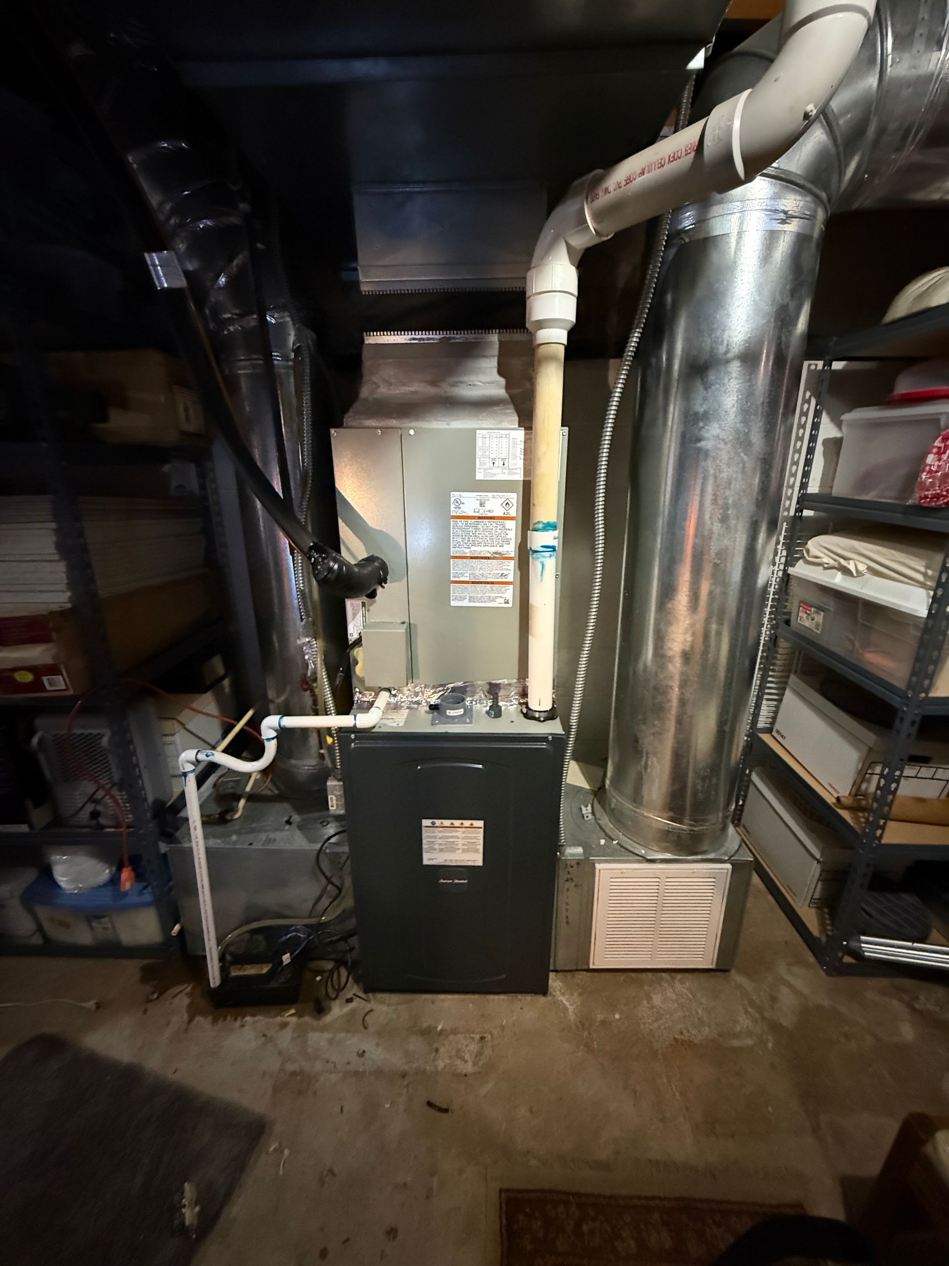 Basement furnace and HVAC equipment with metal ducts and pipes in a utility room