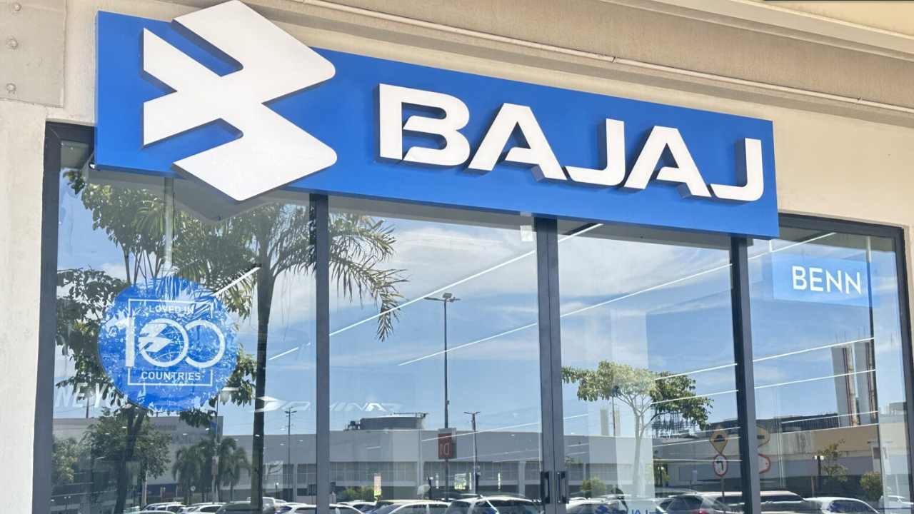 Bajaj store front with blue and white logo, reflections in windows.