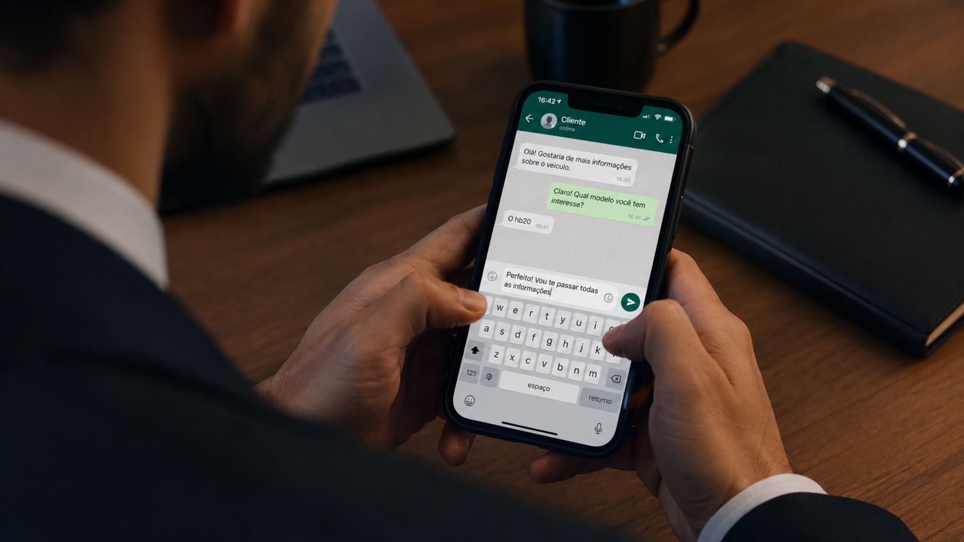 Person typing on a smartphone with a messaging app open at a desk with a notebook and pen.