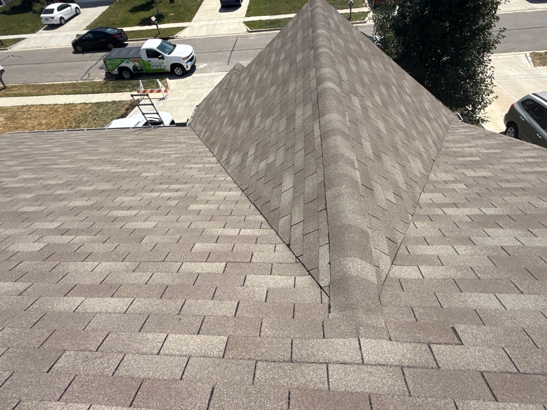 Roof with brown shingles and a triangular peak.