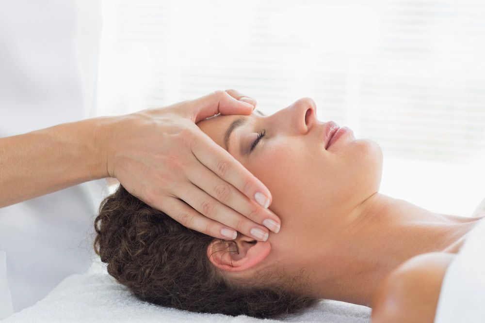 A Woman Is Getting A Head Massage At A Spa — Phoenix Mandorla In Rockhampton City, QLD