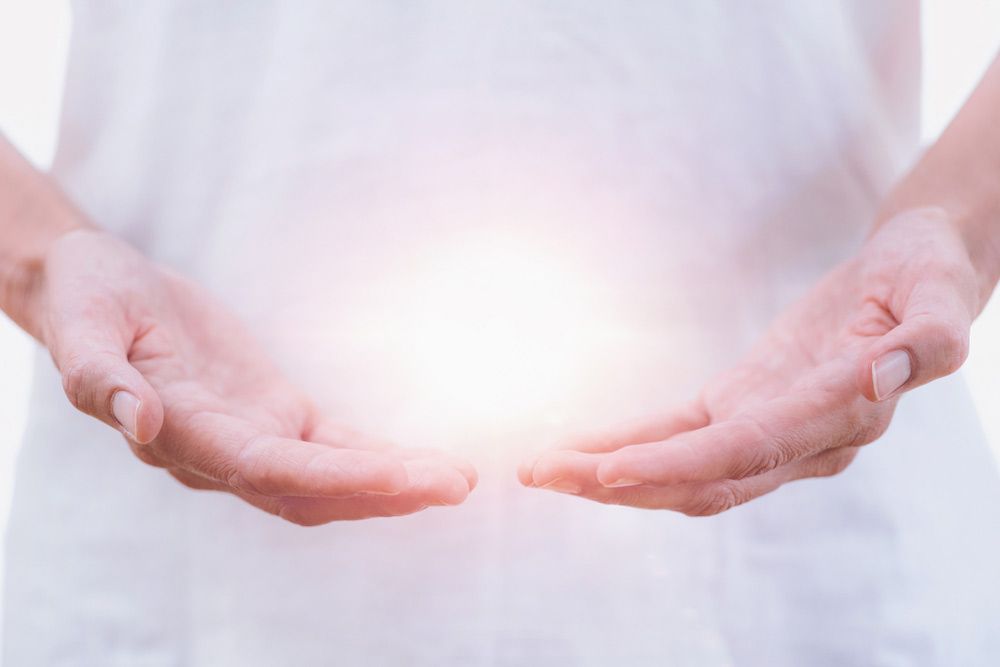 A Person Is Holding A Light In Their Hands — Phoenix Mandorla In Rockhampton City, QLD