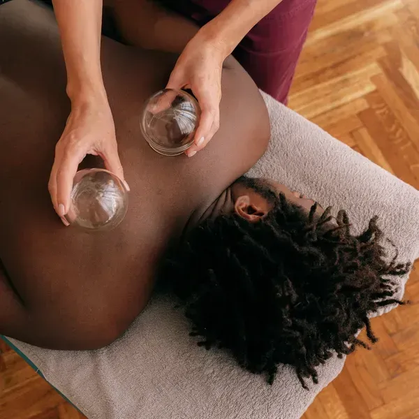A Man Is Lying on His Sromach with Cupping on His Back— Phoenix Mandorla In Central Queensland, QLD