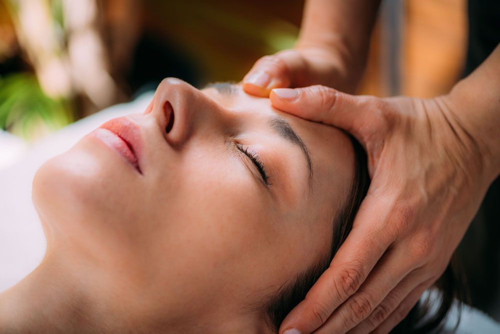 A Woman Is Getting A Head Massage At A Spa — Phoenix Mandorla In Rockhampton City, QLD