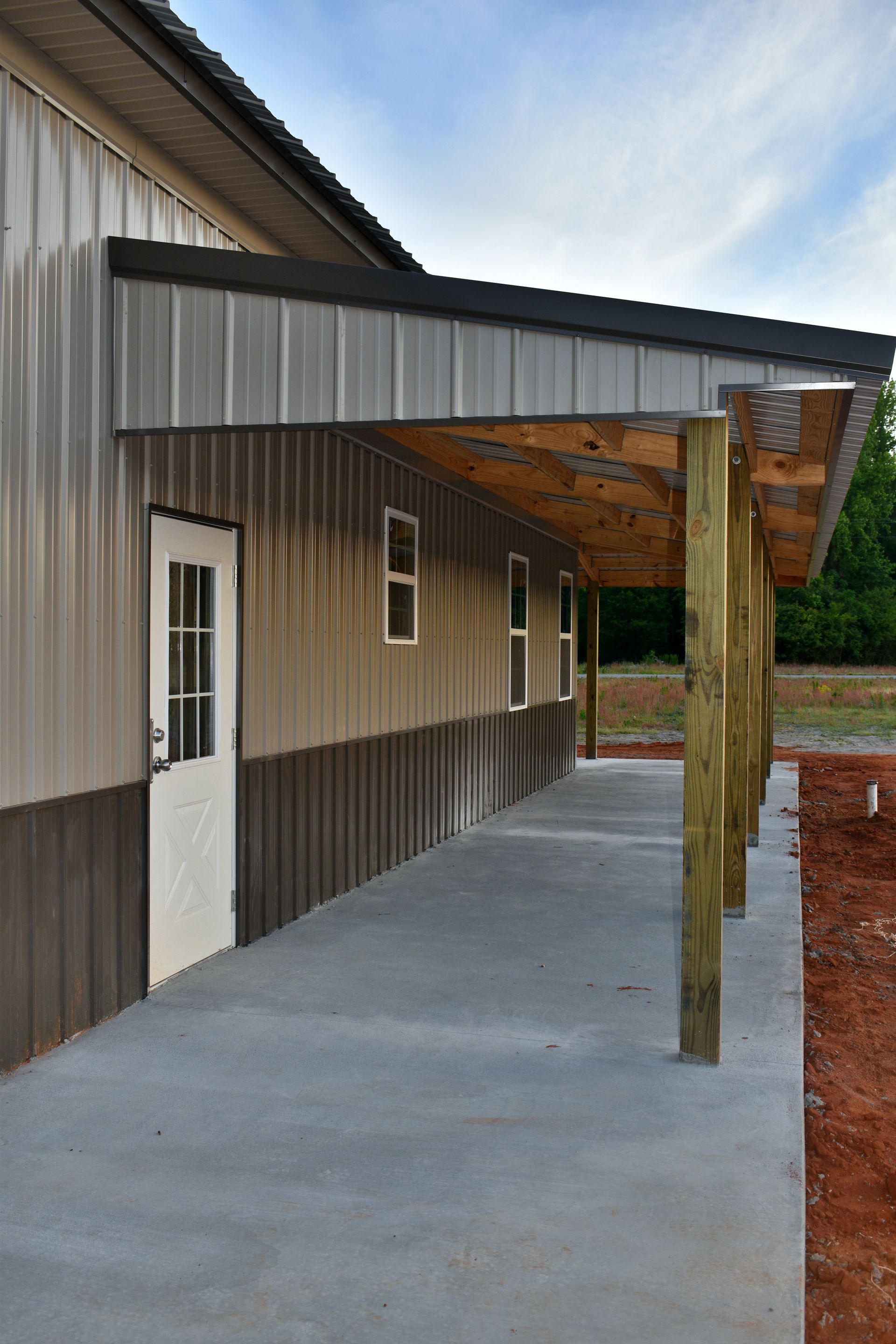 A metal building with a porch and a door.