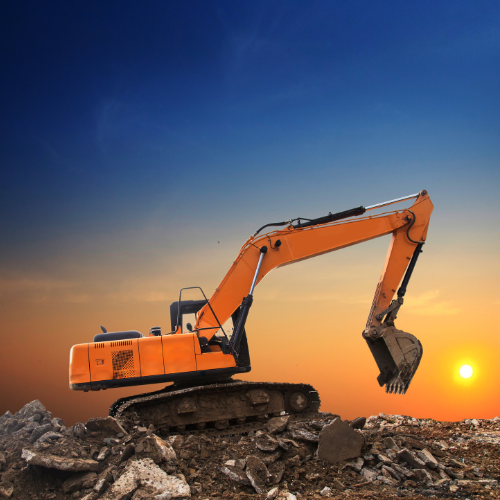 An orange excavator is sitting on top of a pile of rocks.
