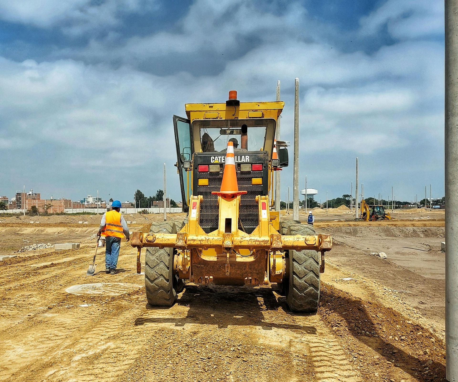 A yellow construction vehicle with a cone on the front