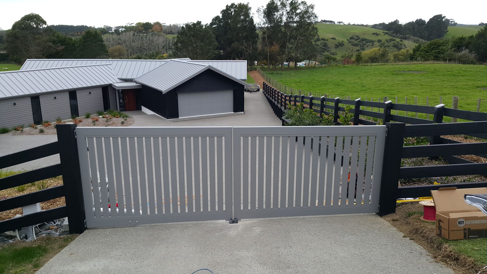 A house with a fence and a gate in front of it