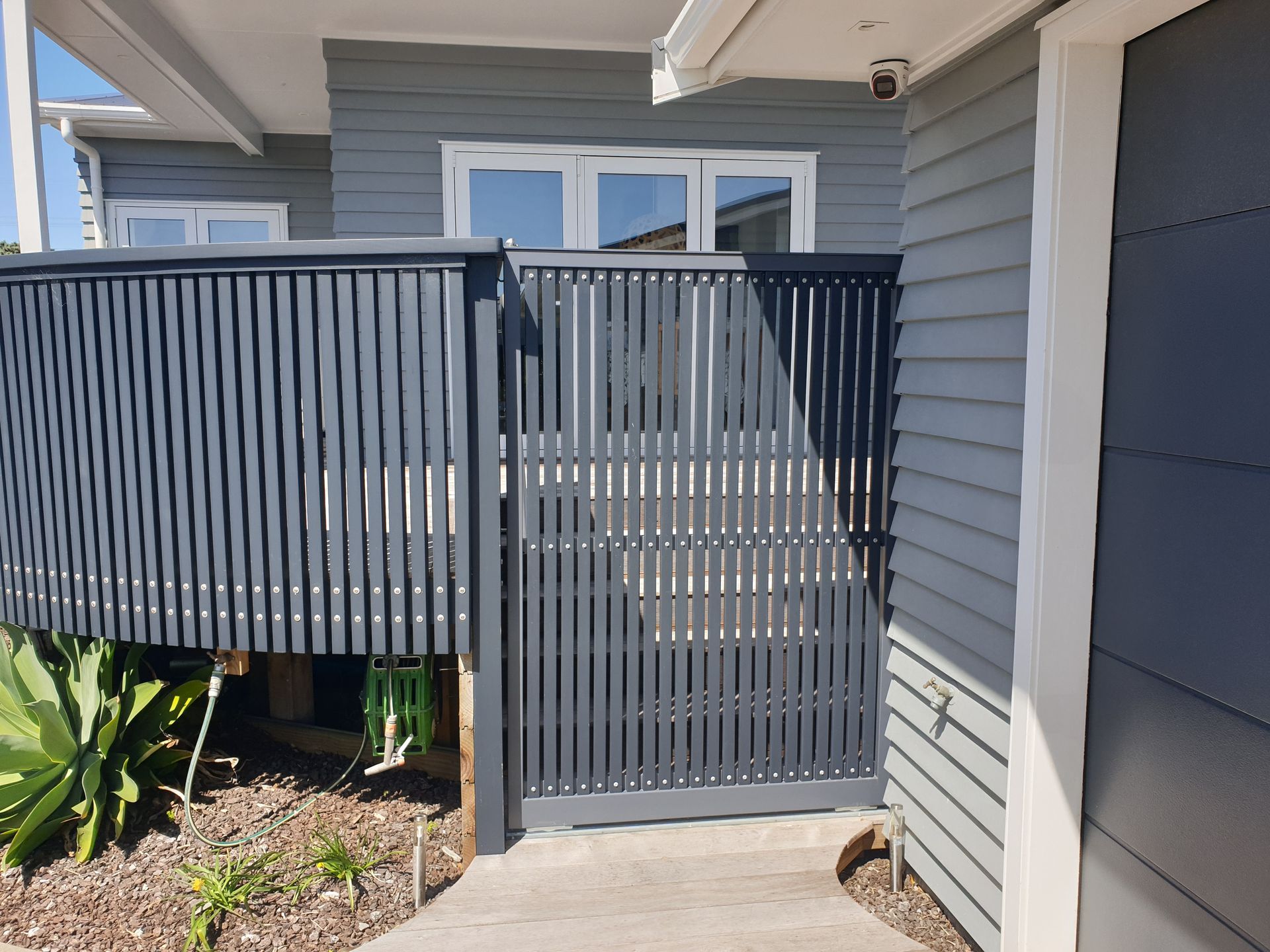 A house with a fence around it and a gate