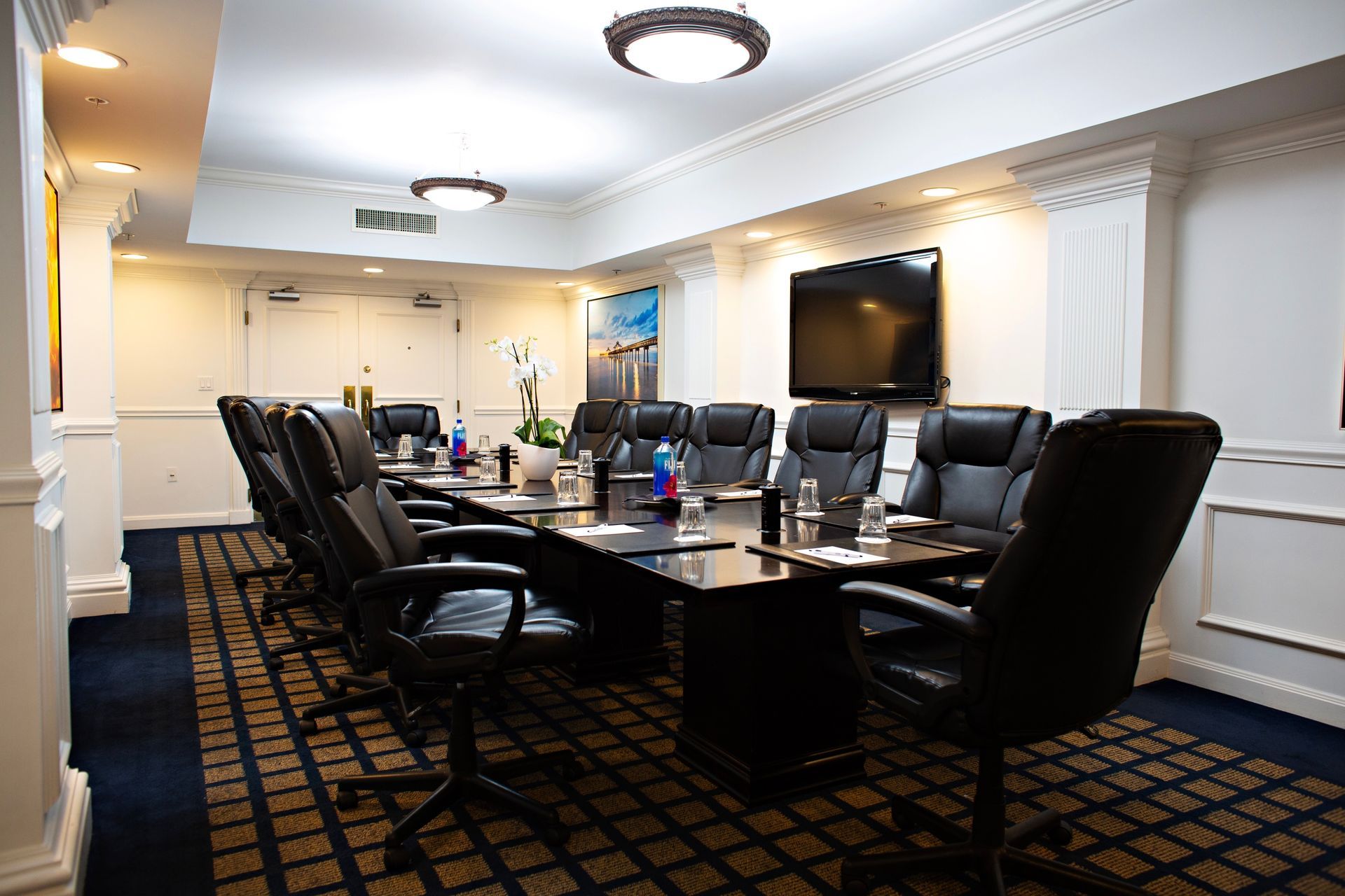 A large conference room with a long table and chairs